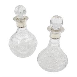 Two small modern silver mounted cut glass decanters, the first example of squat bulbous form, the body with navette, octagonal and hobnail cut decoration, with conforming stopper, the silver collar hallmarked Barker Ellis Silver Co, Sheffield 2005, H19cm, the second example, a ships decanter, with hobnail cut star decoration and conforming stopper, the silver collar hallmarked C J Vander Ltd, Sheffield 2005, H19cm, with boxes