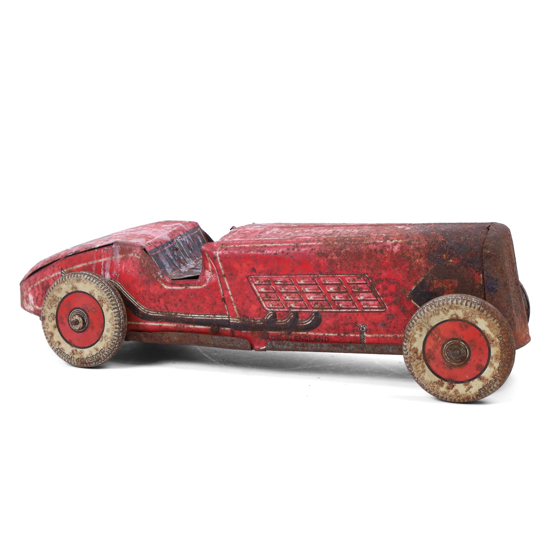 Mettoy tinplate clockwork racing car, the boat tailed red body with lithographed details, racing no. 7, with Dunlop Fort tyres, for restoration, H8cm, L32cm