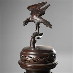 Japanese late Meiji period bronze koro and cover, surmounted by an eagle finial and with bird decoration in high relief to each side, twin elephant trunk handles, bearing indistinct character signature to one side, H82cm