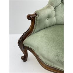 Victorian walnut armchair, scroll carved arm terminals and cabriole supports, upholstered in green buttoned fabric