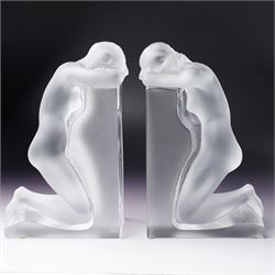 Pair of Lalique 'Reverie' glass bookends formed as two kneeling nude figures in clear and ...