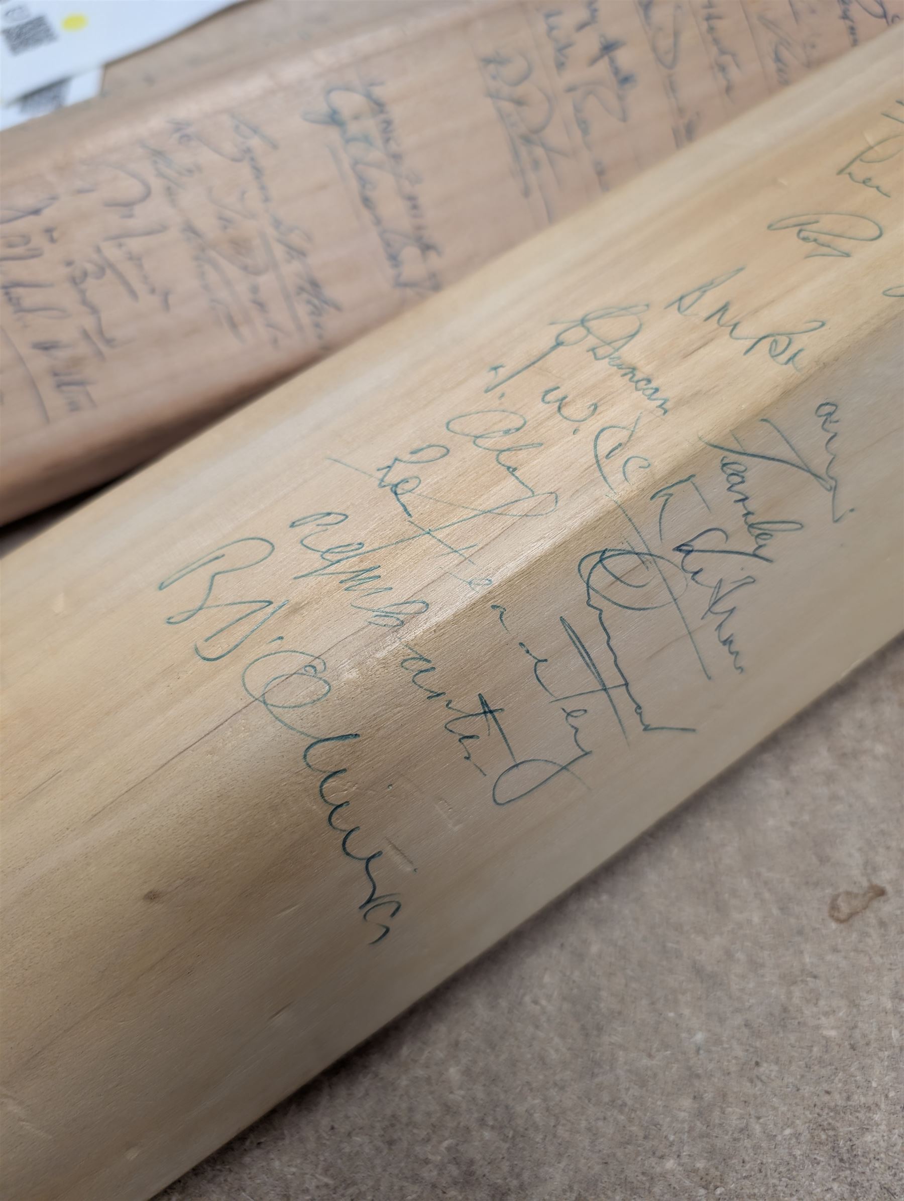Two signed cricket bats, with signatures including Colin Cowdrey