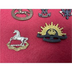 Forty glengarry and cap badges and shoulder titles including Gordon Highlanders, Canada and Canadian Field Artillery, New Zealand Field Artillery and Rifle Regiment, Shropshire Light Infantry, 14th/20th Kings Hussars, 17th Lancers, Northamptonshire Yeomanry, Royal Lincolnshire, Special Air Service, 19th Alexandra P.W.O. Hussars etc; mounted on two boards for display (2)