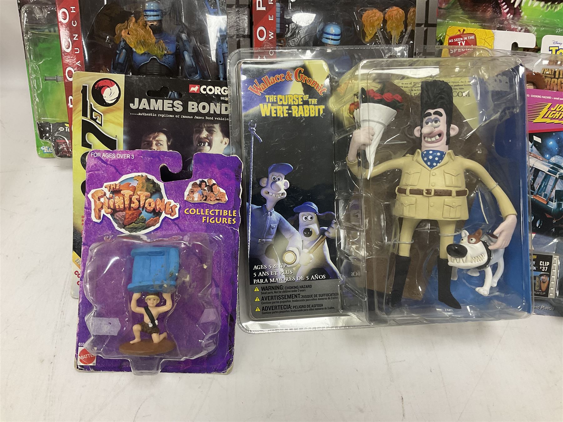 Fourteen carded action figures comprising Toy Story, X-Men Marvel Legends, Lord of the Rings, The Lost World Jurassic Park (2), The Secret Saturdays, Wallace & Gromit, Corgi Tom & Jerry (4), Flintstones, Lost in Space and Disney Infinity Cars; all in unopened blister packs; together with two boxed Robocop figures and carded James Bond car (17)