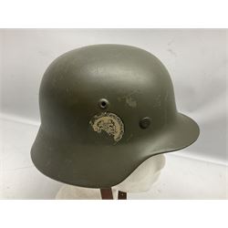 German M35 style steel helmet marked ET60 to the side skirt and 4197 to the back apron, the leather liner with impressed makers mark for 'Schuberth Werke KG Braunschweig 19 60 37' and stamped 53, chin strap and drab green paintwork with traces of two decals