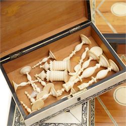 Mid-19th-century Anglo Indian Vizagapatam ivory, sandlewood, and horn veneered backgammon/chess board, circa 1860, rectangular games box the borders engraved with a stylized scrolling leaf decoration and spine engraved History of Persia the interior inlaid for backgammon, with three internal sandalwood boxes with covers, containing 16 ivory pieces and 16 horn pieces, comprising, kings and queens with pierced crowns on baluster carved shafts; bishops with carved mitres; knights represented by horses’ heads; and rooks as towers with imbricated decoration.

This item has been registered for sale under section 10 of the APHA Ivory Act, submission reference G68PNYA5 

