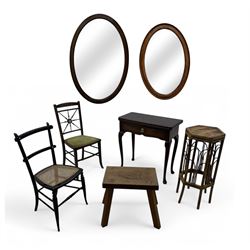 Late 19th century black-painted cane seat chair; early 20th century radial spindle-back chair with green upholstery; early 20th century mahogany single-drawer side table; mid-20th century carved wooden stool with harp motif; early 20th century hexagonal bamboo stand; two oval mirrors (7)
