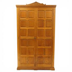 Beaverman - Yorkshire oak panelled double wardrobe, with carved pediment, panelled doors and sides, with internal top shelf above a single hanging rail, with carved beaver signature, by Colin Almack of Sutton near Thirsk