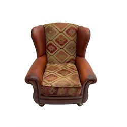 Wingback armchair, upholstered in studded red leather and kilim style fabric