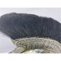 Early 20th century French mounted gendarme's helmet, brass with nickel-silver mountings, broad band embossed with fused grenade, high comb with the face of the gorgon Medusa at the peak and with a black horse hair crest, plume socket at the left, leather-backed nickel-silver chin scales with lion mask mounts.