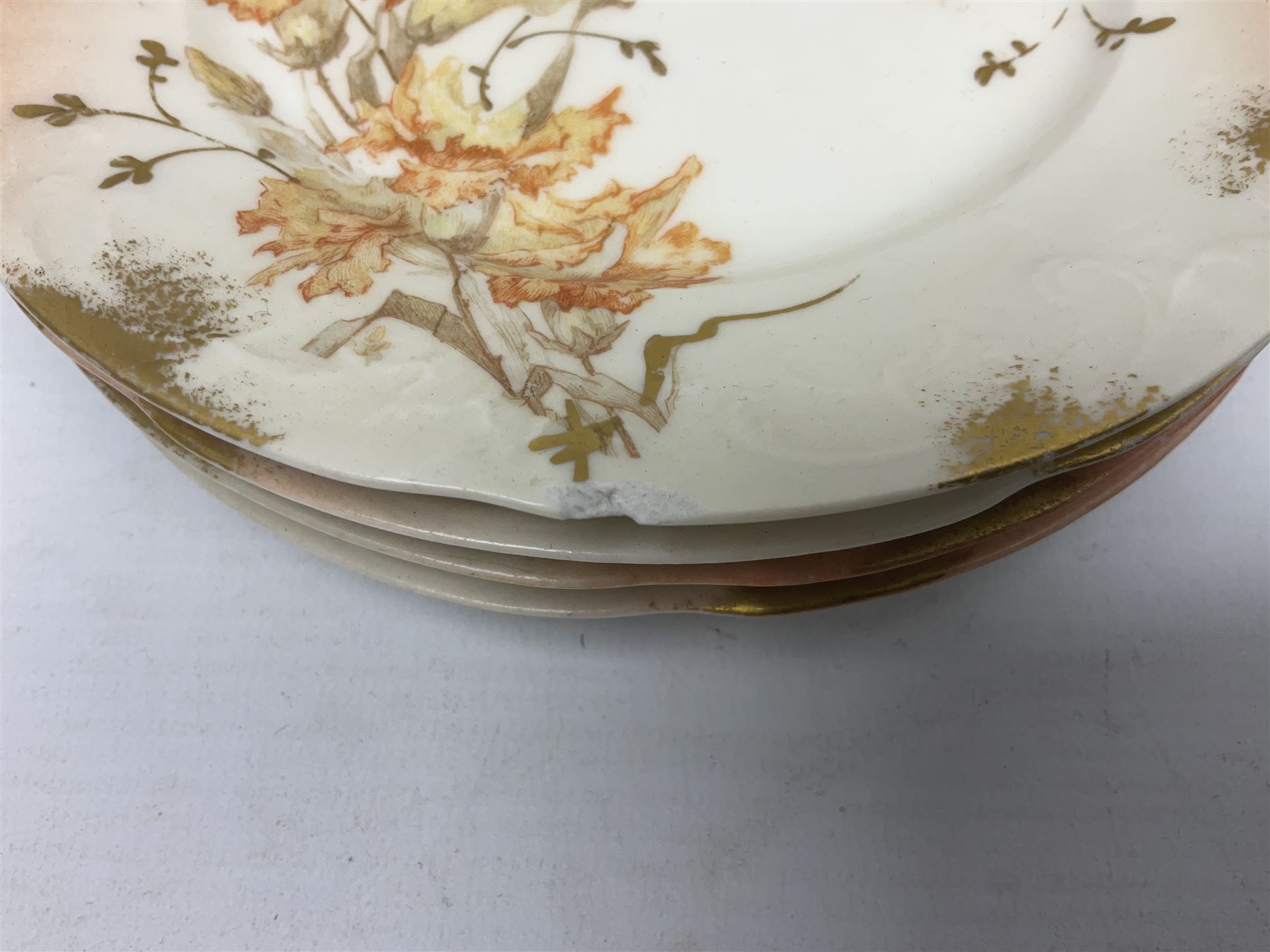 Early 20th century Limoges part tea service, decorated with floral sprays and gilt on merging peach and white ground, comprising six teacups, twelve side plates, six smaller plates, milk jug, open sucrier, slop bowl and two cake plates, many marked R Delinieres Limoges D&C France to base