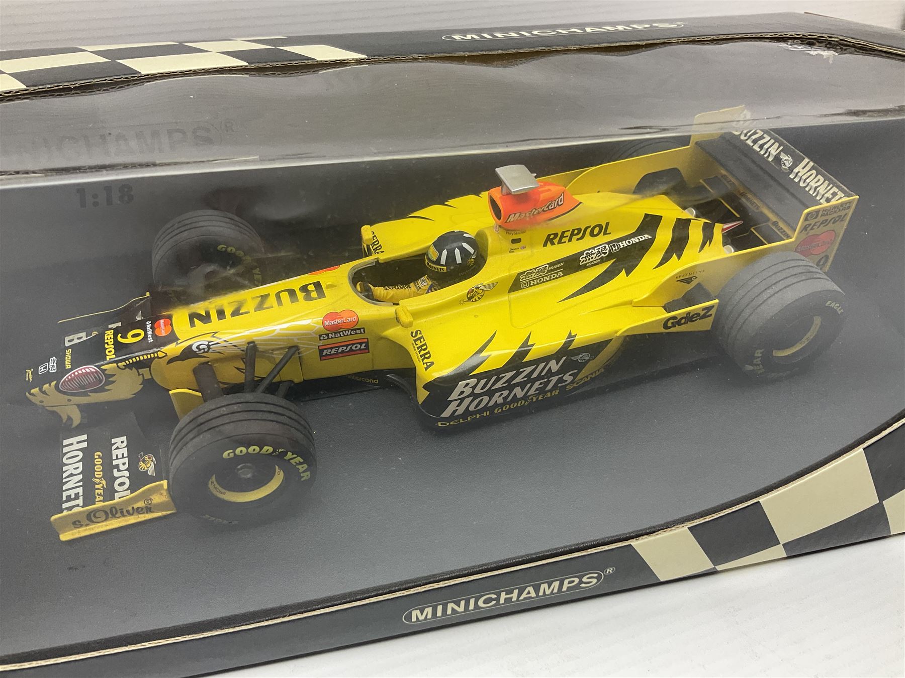 Three Minichamps 1:18 scale die-cast racing cars - Jordan Mugen Honda 198 D. Hill; Jordan Ford EJ13 G. Fisichella; and Stewart Ford SF 1 R. Barrichello; all boxed (3)