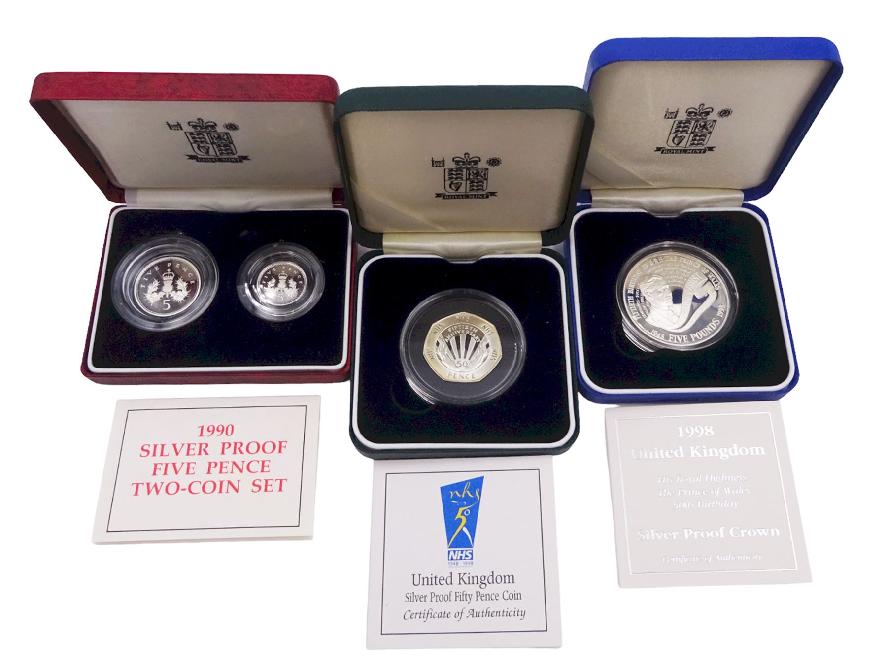 The Royal Mint United Kingdom silver proof coins, comprising 1990 five pence two-coin set, 1998 'His Royal Highness The Prince of Wales Fiftieth Birthday' crown, and 1998 'NHS 1948 -1998' fifty pence coin, all cased with certificates