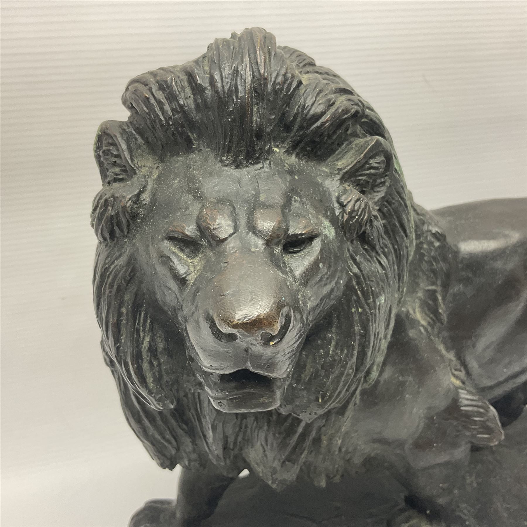 After Paul Edouard Delabrierre (French, 1829-1912), bronze, model of a lion, upon an oval base, signed E Delabrierre, overall H29.5cm, L46cm