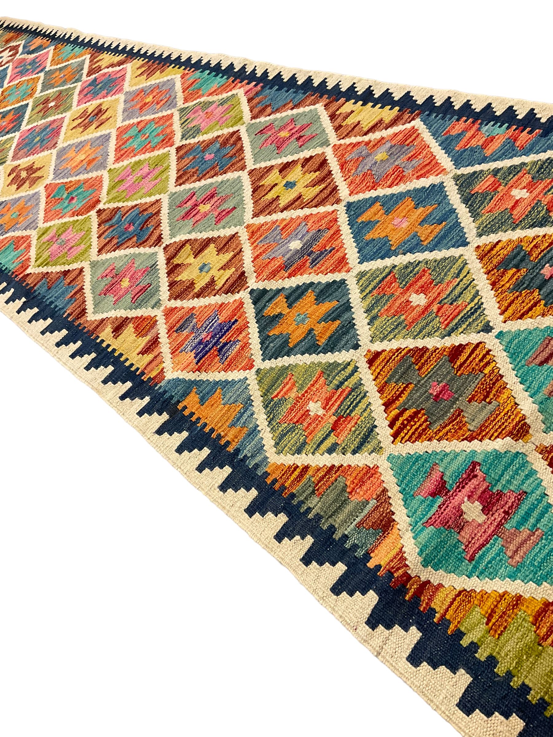 Anatolian Turkish Kilim ivory ground runner rug, decorated with all over multi-colour geometric lozenges with ivory outline