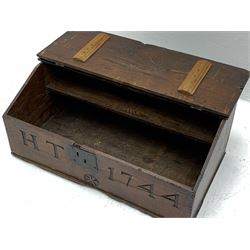 18th century boarded oak desk box, the sloped hinged lid with moulded edge, above front inscribed 'H.T 1744' and carved with star motif, with iron lock and hinges, opening to reveal an interior fitted with single shelf, H30cm L73cm D40cm 