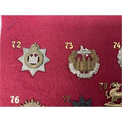 Twenty-two glengarry and cap badges including Argyll & Sutherland, Devonshire, Essex, Hampshire, Royal Berkshire, Northamptonshire, Long Range Desert Group, Royal Corps of Signals, Norfolk, Dorsetshire, East Lancashire etc; mounted on a board for display