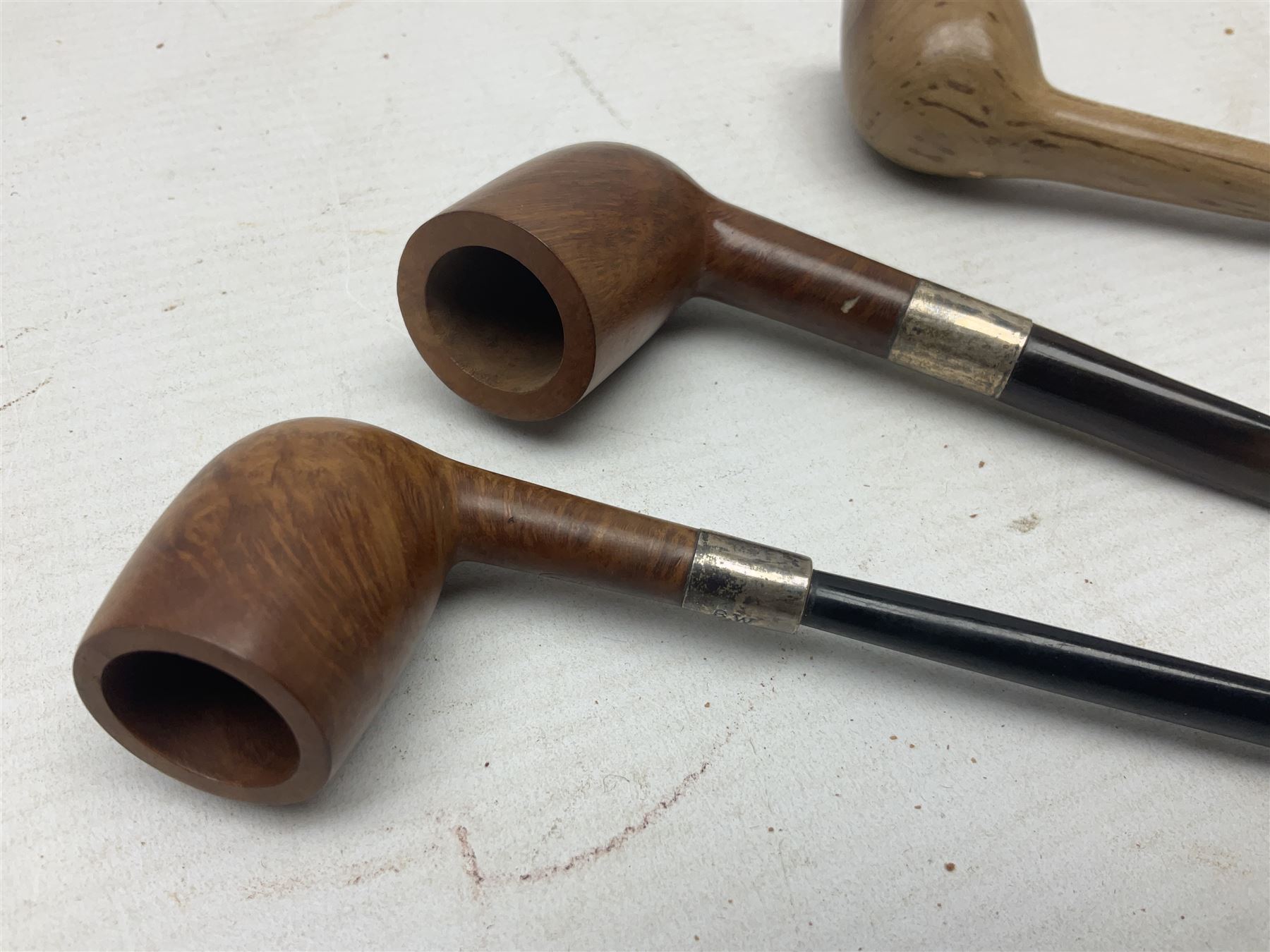 Collection of eight silver mounted pipes, comprising a briar wood Imperial ITC example with silver collar hallmarked A.W Birmingham 1903, horn handled example with silver collar hallmarked LB, probably Louis Blumfeld, Birmingham 1900, three examples marked B.W, one marked Globe A.O.C, Blumfeld's Best Briar pipe marked BBB and Riseagle example, together with two further pipes (10)