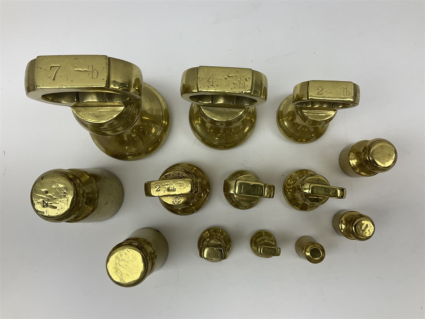 Graduated set of eight brass bell weights, together with a set of five graduating weights (13)