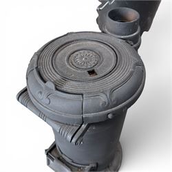 Late Victorian cast iron stove of small proportions, decorated with scrolls and central rosette to the top