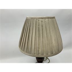 Turned wooden table lamp with a circular plinth base together with a similar example, both with pleated lampshades, tallest example H70cm 