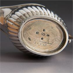 Victorian silver four piece tea service, comprising coffee pot, teapot, twin handled open sucrier and milk jug, all of oval part fluted form and engraved with initial to body, the coffee pot on oval stepped foot, coffee pot and teapot with ebonised wooden finials, hallmarked Elkington & Co, Birmingham 1888