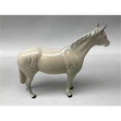 Collection of Beswick horses, including grey horse no.701, palomino foal no 836, grey stocky jogging mare no.855 etc, together two Royal Doulton horses, (8)