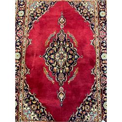 Persian rug, the red ground field decorated with floral design medallion and spandrels, guarded border with repeating floral design