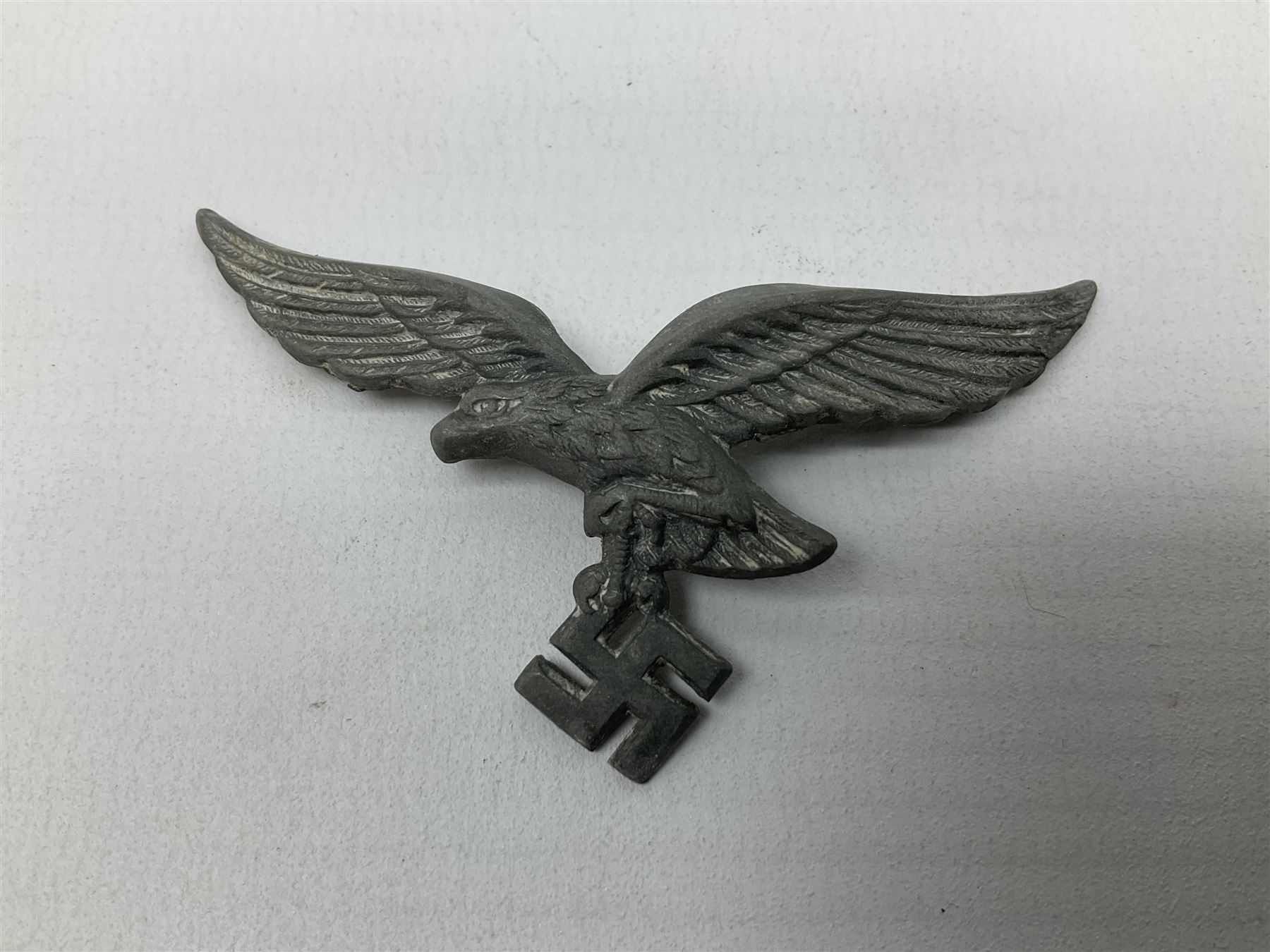 Five WW2 German peaked cap badges, four with double-pinned backs