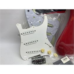 Disassembled Squier guitar and quantity of unused Fender guitar parts