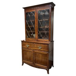 Georgian mahogany secretaire bookcase, projecting moulded and dentil cornice over two Gothic arch astragal glazed doors, reeded slip mouldings with split turnings, enclosing four adjustable shelves, the secretaire with fall front drawer enclosing a well fitted interior, series of small drawers, pigeons holes and baize writing surface, two panelled cupboard doors below, fitted with linen slides, on splayed bracket feet