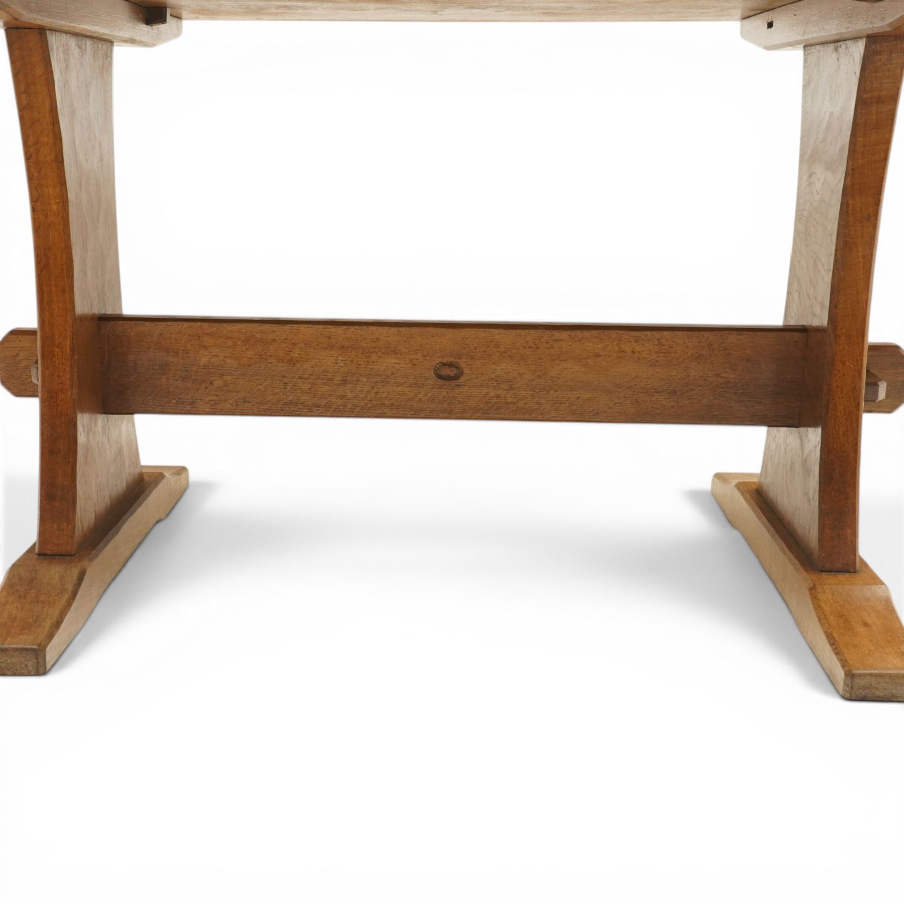 Acornman - 5' adzed oak dining table, rectangular top above a trestle base united by a stretcher with carved acorn signature, by the workshop of Alan Grainger of Brandsby