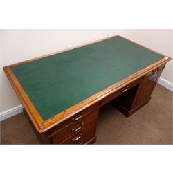  Edwardian oak twin pedestal desk, inset green leather top, moulded edges, six drawers and single cupboard, plinth base, W174cm, H77cm  
