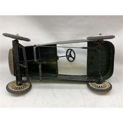 Mid 20th century pressed steel pedal car, the body painted in dark green fitted with pretend radiator to the bonnet, with spoked wheels and rubber tyres, the interior with pedals and steering wheel, L70cm