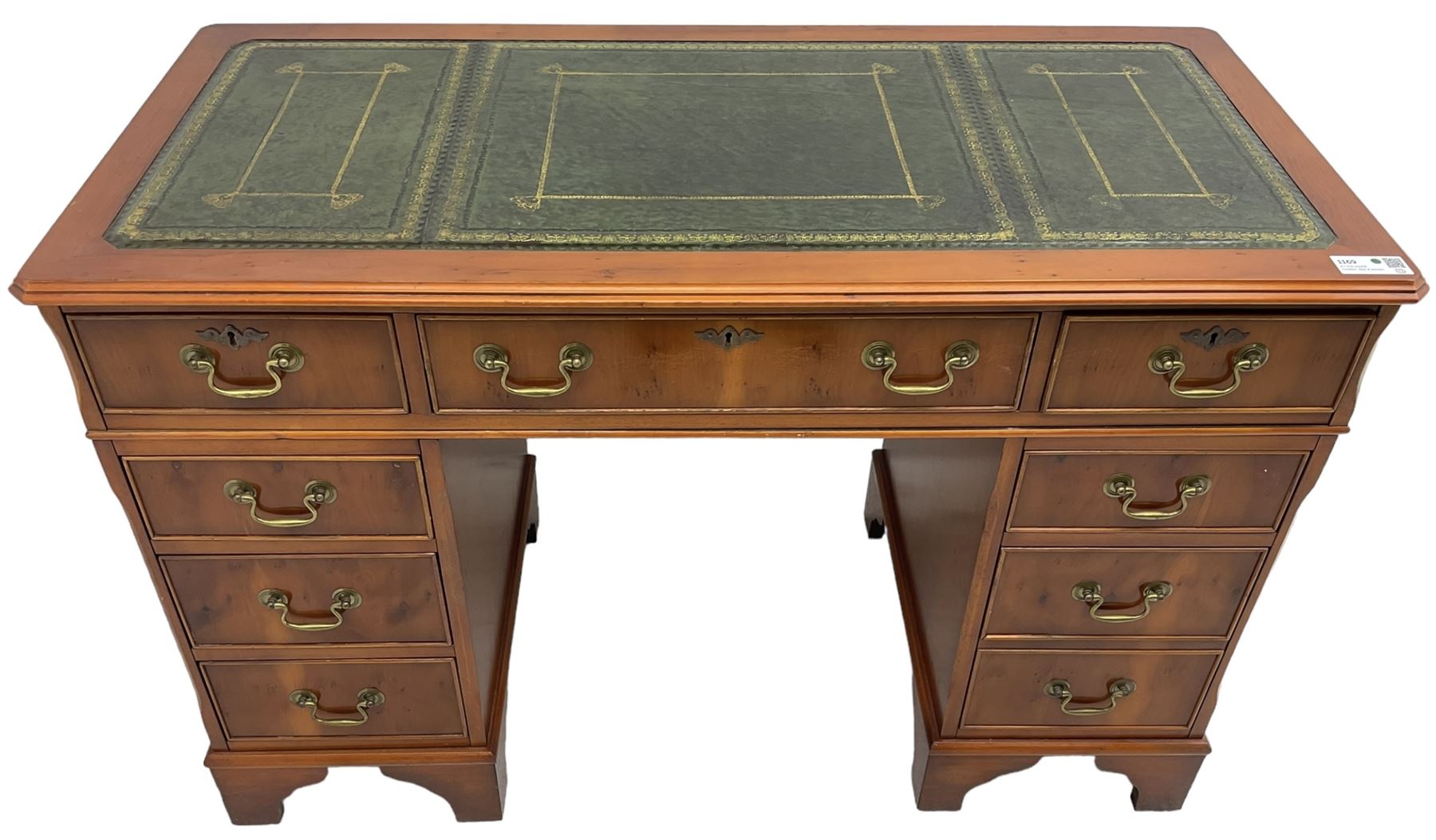 Georgian design yew wood twin pedestal desk, rectangular top with green leather inset writing surface, fitted with nine cock-beaded drawers, on bracket feet