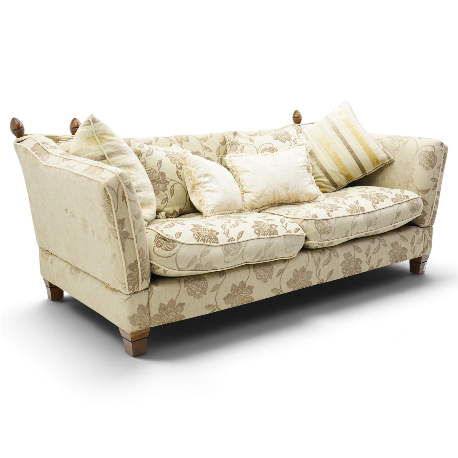 Traditional knoll sofa, upholstered in cream and olive floral fabric, adjustable drop ends secured by cords to turned finials, loose seat and back cushions with piped edges, on square tapering feet, with four scatter cushions