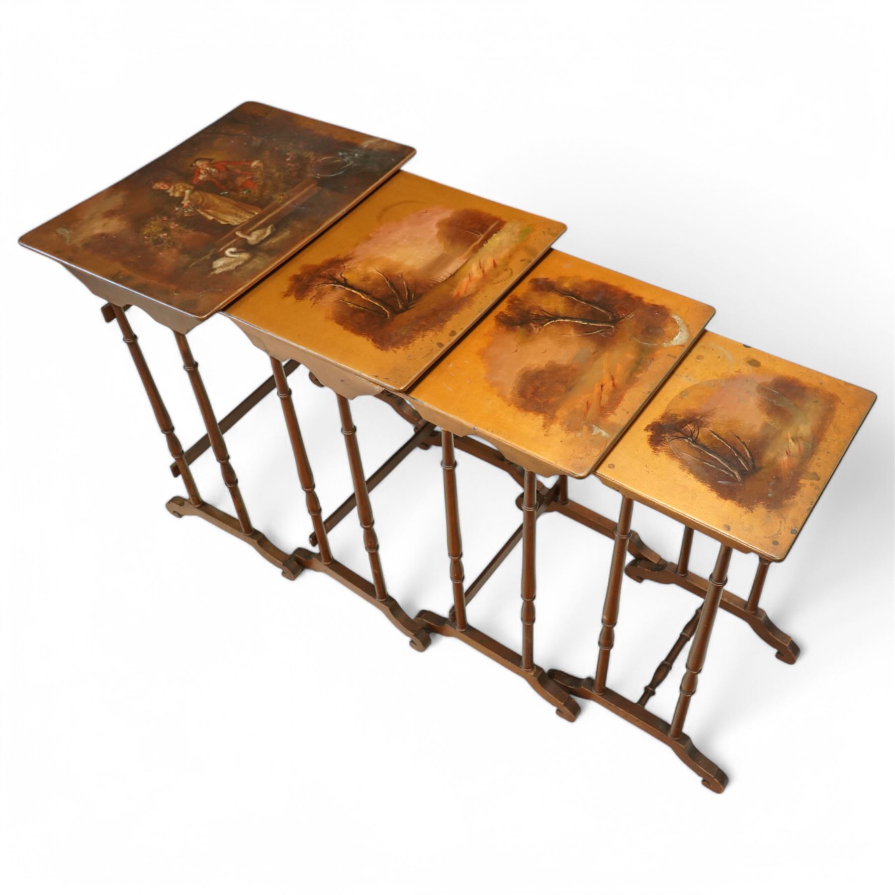 French 19th century painted nest of tables, the largest depicting a romantic scene of courting lovers by a swan lake, indistinctly signed L Desi**, the smaller tables painted with rural landscapes, the painted rectangular tops raised on ring turned end supports united by stretcher