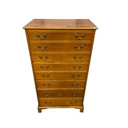 Mid-20th century oak straight-front chest, fitted with eight graduating drawers, raised on bracket feet