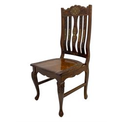 Pakistan carved hardwood brass inlaid circular dining table, and four rail back chairs with saddle seats