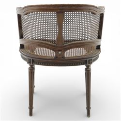 Late 19th century cane bergère armchair, the serpentine shaped back flowing into enclosed arms, the back and seat caned throughout, with carved detail to the crest and arm terminals, on turned legs