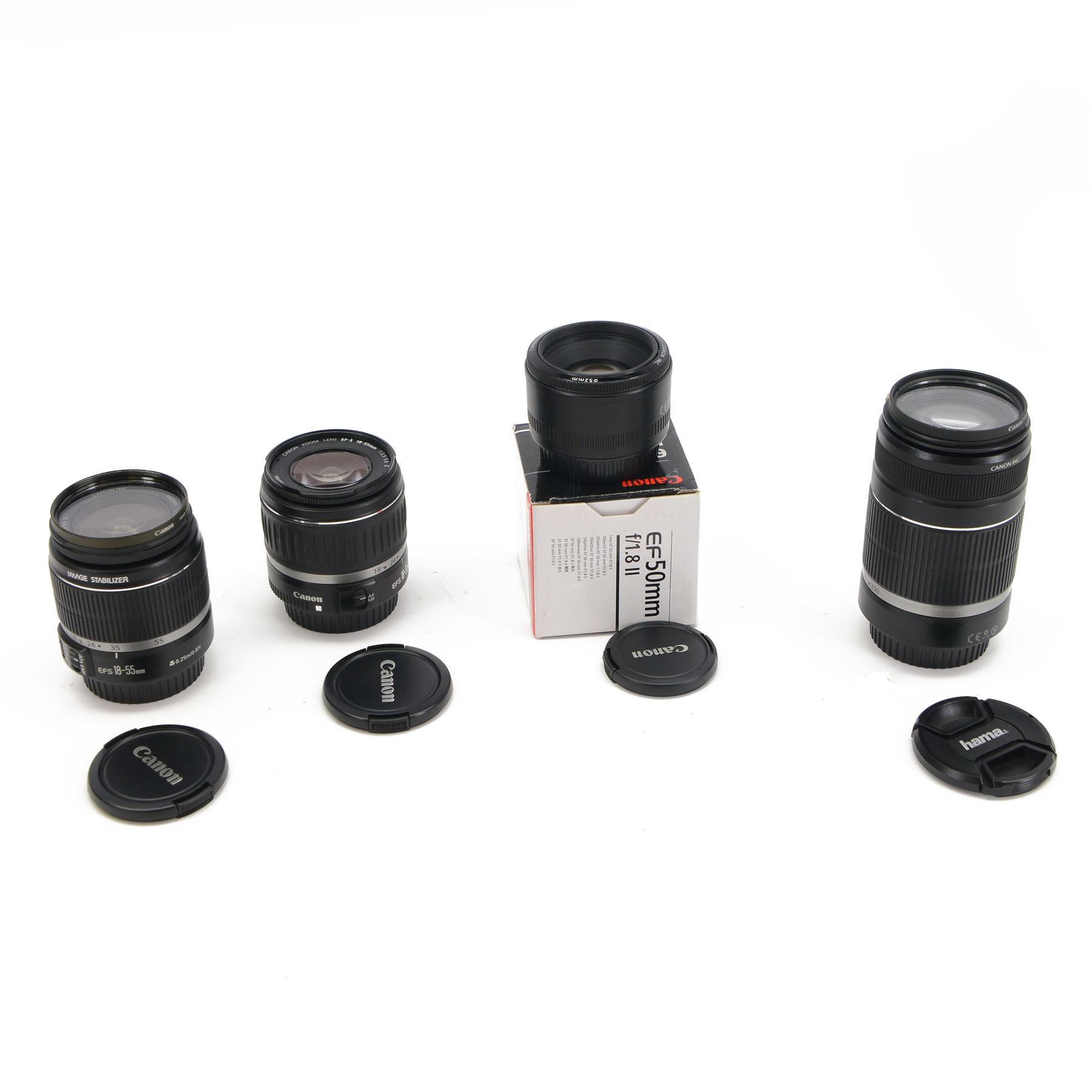 Four Canon camera lenses, comprising EF 50mm 1:1.8 lens serial no. 70896512, boxed, two zoom EF-S 18-55mm 1:3.5-5.6 IS lenses serial nos. 2040537810 and 6462009965 and an EF-S 55-250mm 1:4-5.6 lens serial no. 67007517