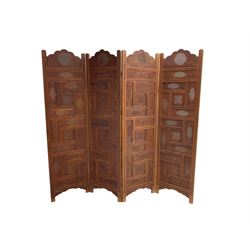 Indian heavily carved hardwood four panel screen, each fold comprised of rectangular panels pierced and carved with scrolling flower heads and floral decoration, each panel W51cm H187cm