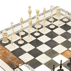 Mid-19th-century Anglo Indian Vizagapatam ivory, sandlewood, and horn veneered backgammon/chess board, circa 1860, rectangular games box the borders engraved with a stylized scrolling leaf decoration and spine engraved History of Persia the interior inlaid for backgammon, with three internal sandalwood boxes with covers, containing 16 ivory pieces and 16 horn pieces, comprising, kings and queens with pierced crowns on baluster carved shafts; bishops with carved mitres; knights represented by horses’ heads; and rooks as towers with imbricated decoration.

This item has been registered for sale under section 10 of the APHA Ivory Act, submission reference G68PNYA5 

