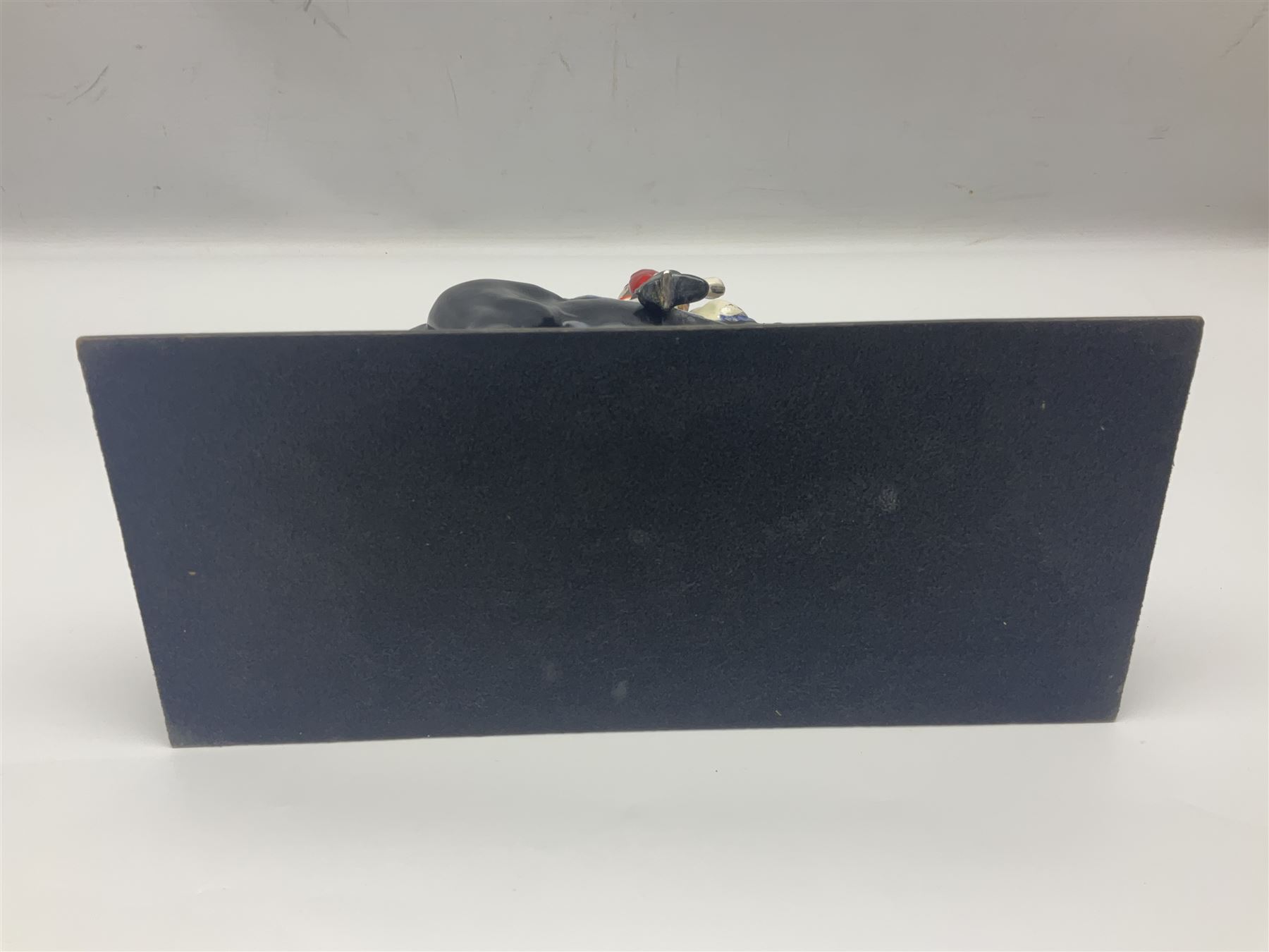 Mounted Lifeguard upon a black horse, in the style of Beswick, upon a wooden plinth, H31cm