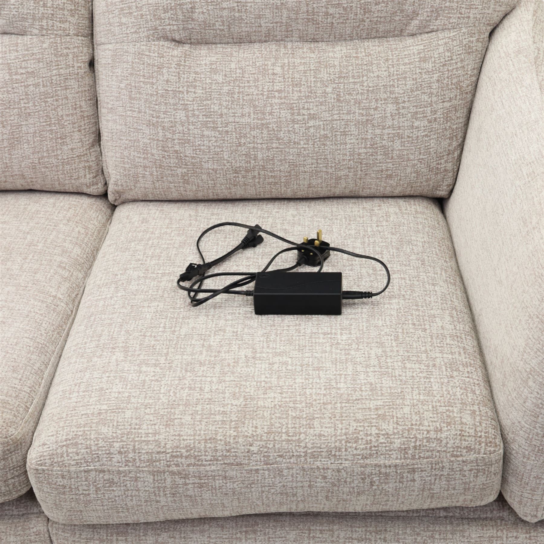 Ashwood - ‘Calypso’ 2-seater motion lounger, upholstered in light stone grey textured fabric with flared arms and split back cushions, fitted with dual electric recline controls, raised on stained tapering legs