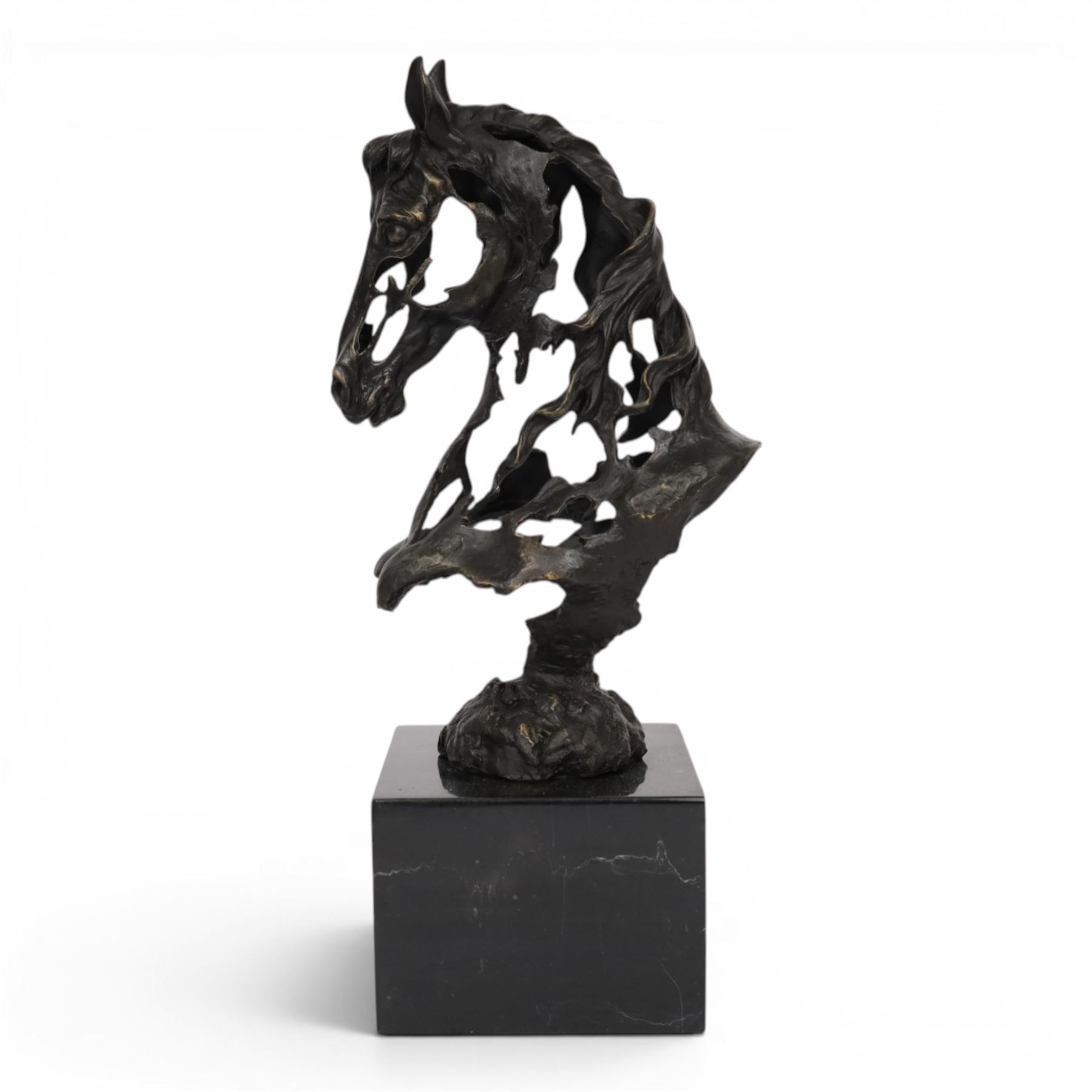 Stylised bronze model of an openwork horses head, signed Gadi and with foundry mark, raised upon black marble plinth, H41cm