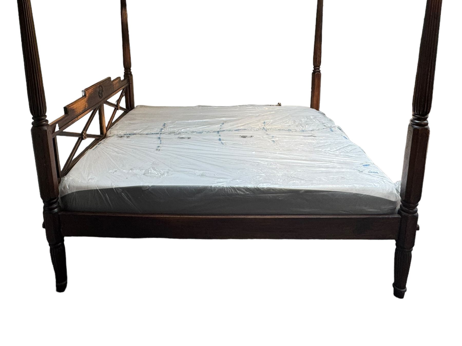 Georgian design Indian sheesham hardwood framed four poster bed, lattice slats to the top supported by reeded cylindrical and octagonal column uprights, the pierced stepped headboard carved with floral motifs, with associated mattress