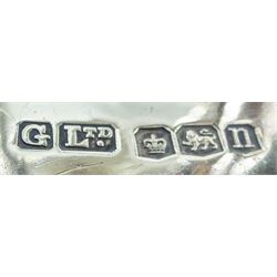 1930's silver model of an American boy scout, in full uniform, with one foot raised upon rocky modelled ground, hallmarked Gladwin Ltd, Sheffield 1930, upon an ebonised circular base, overall H31cm 