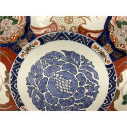 Large early 20th century Japanese Imari wall charger, the centre painted with stylised blue roundel, surrounded by alternating shaped panels of flowers and phoenix, and foo dogs, D46cm