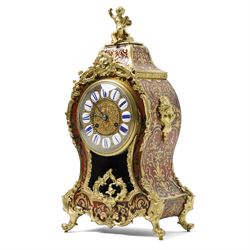 Rollin à Paris - 19th century French Louis XV style ormolu-mounted red tortoiseshell and brass Boulle-work mantel clock, surmounted by a seated musical putto above a waisted case applied with mask, rocaille, foliate and dolphin mounts, the gilt dial with white enamel Roman numeral cartouches, twin-train movement striking on a bell, signed and numbered 480, on four scrolling foliate feet